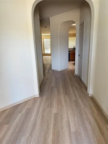 a view of a room with wooden floor