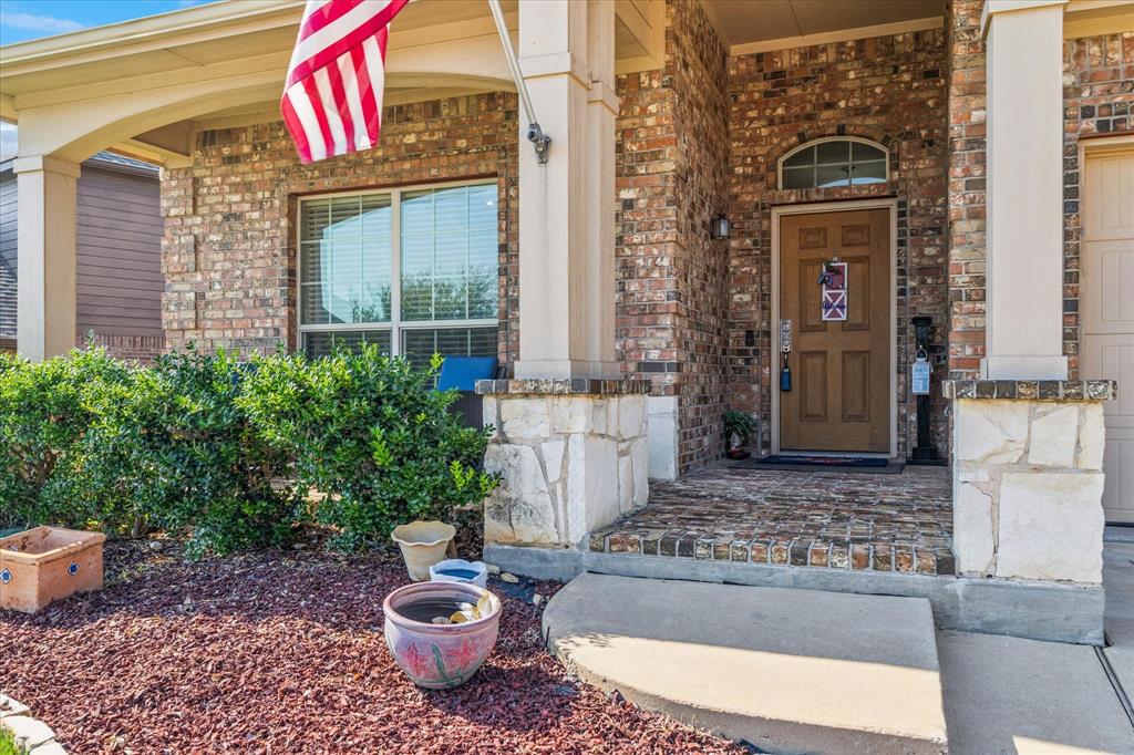 10205 Point Lobos Trail Fort Worth, TX 76177 - Photo 5 of 29 a view of a house with a potted plant and a red door