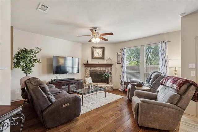 a living room with furniture a large window and a flat screen tv