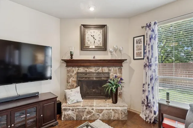 a living room with furniture a flat screen tv and a fireplace