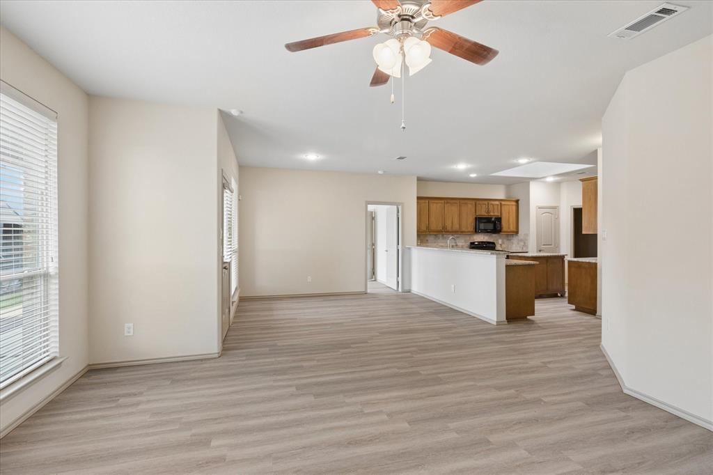 10205 Point Lobos Trail Fort Worth, TX 76177 - Photo 8 of 29 a view of a kitchen with kitchen island a sink stainless steel appliances and cabinets