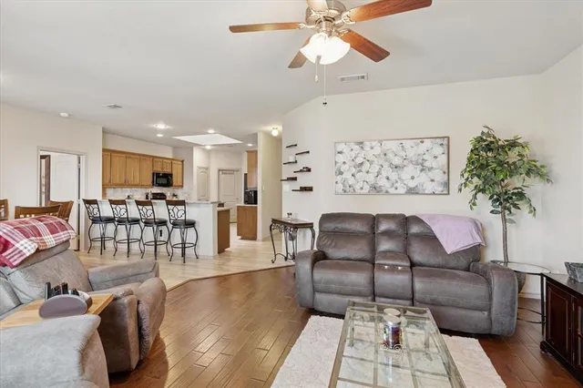 a living room with furniture and wooden floor