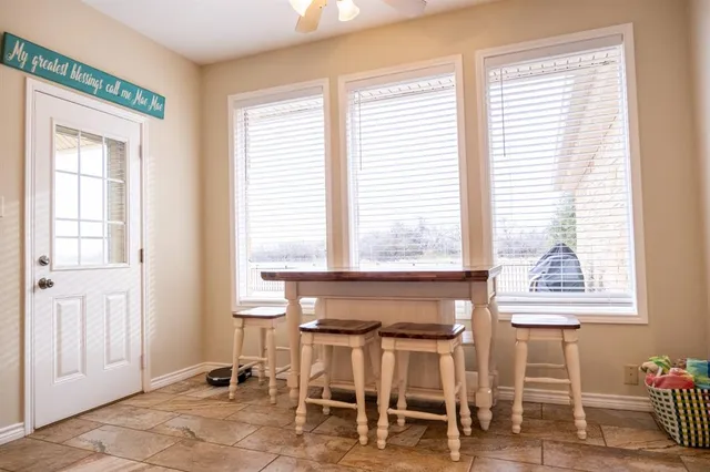 a living room with a table chairs and a window