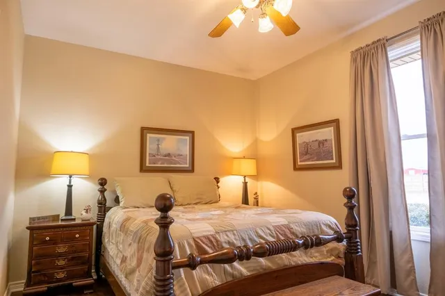 a bedroom with a bed and a lamp