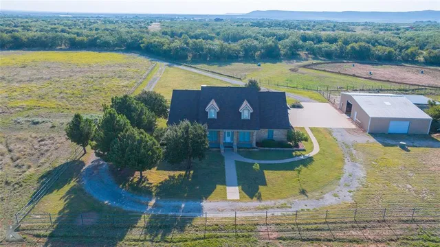 an aerial view of a house with a lake view