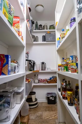 a kitchen with lots of clutter and cabinets