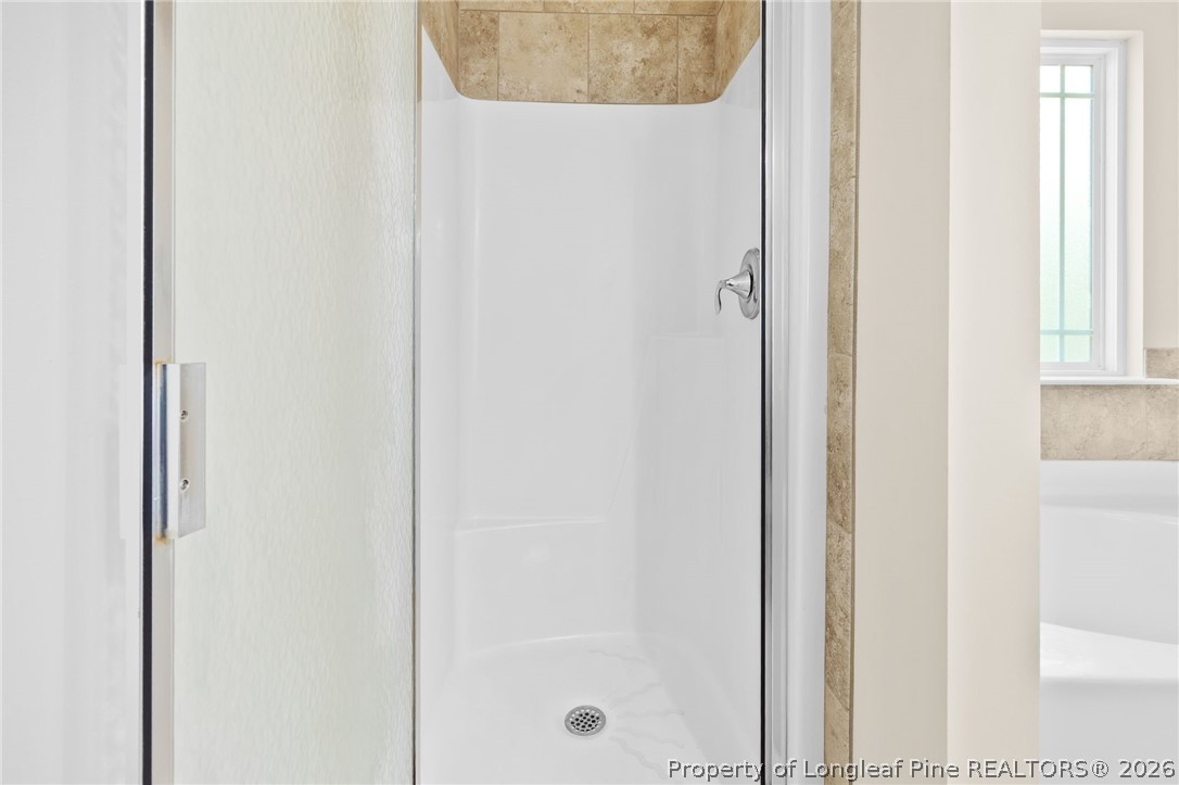 216 Meherrin Loop Raeford, NC 28376 - Photo 20 of 38 a bathroom with a glass shower door