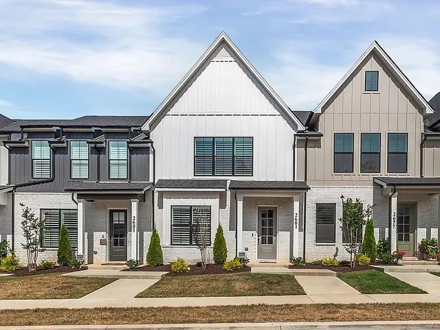 a view of a brick building next to a yard