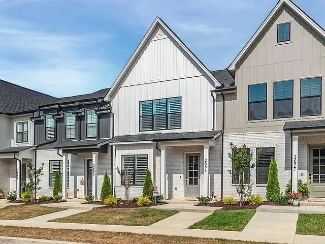 a view of a brick building next to a yard