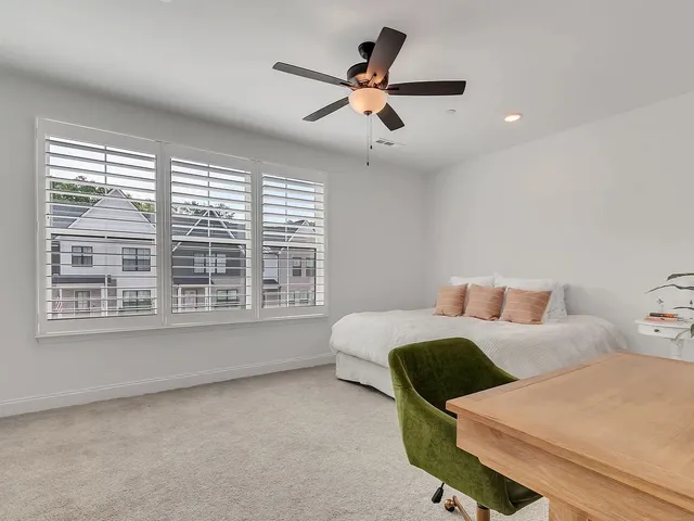 a spacious bedroom with a bed and a large window