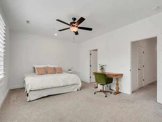 a bedroom with a bed a table and a window