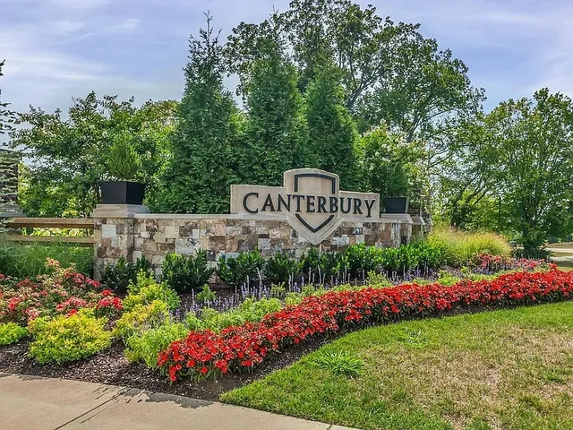 a view of a sign in front of flowers