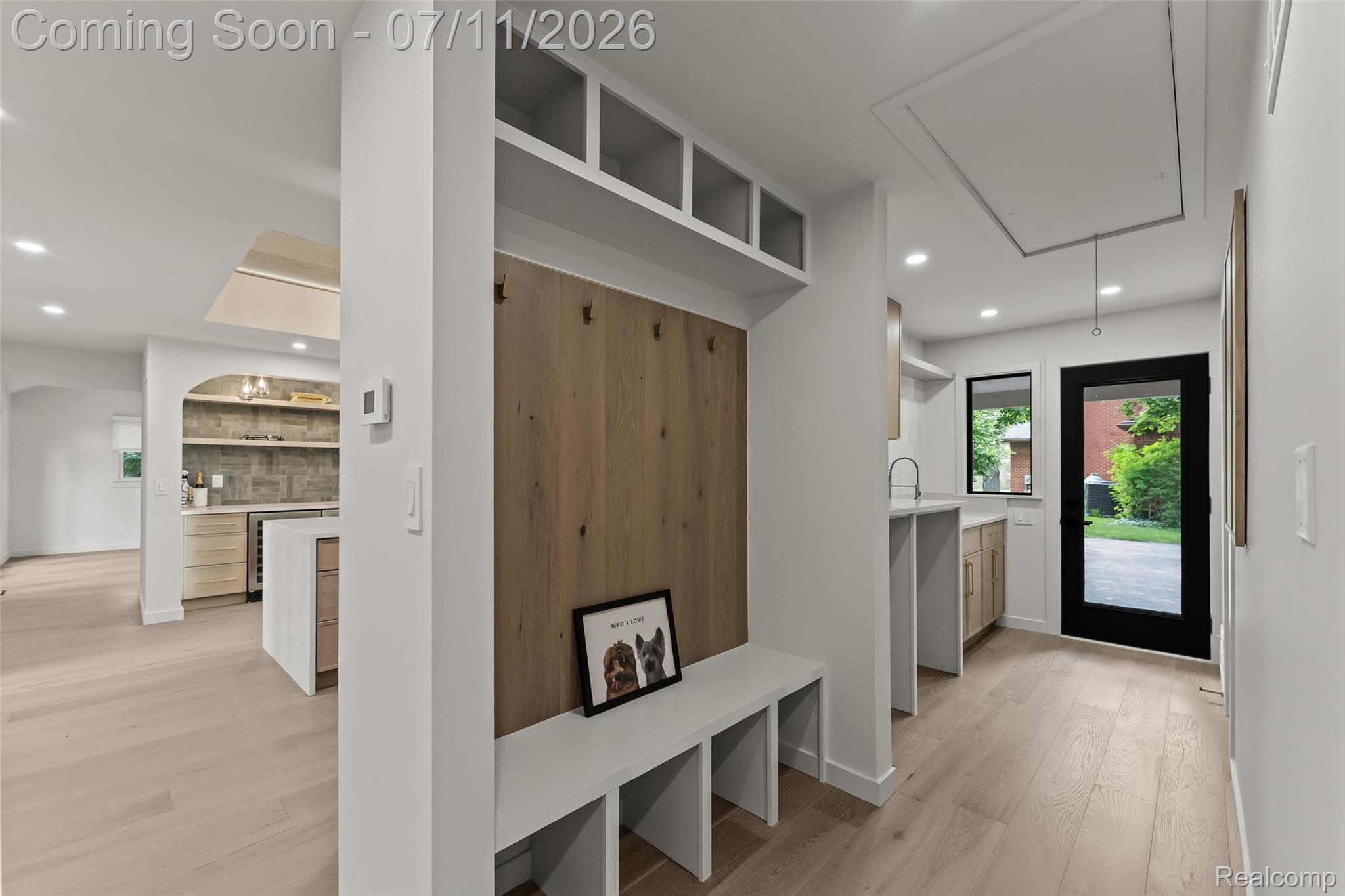 4154 Nearbrook Road Bloomfield Hills, MI 48302 - Photo 21 of 47 Entryway mudroom with built-in bench and cubbies, wood-finish flooring, recessed lighting, and a black-framed glass door