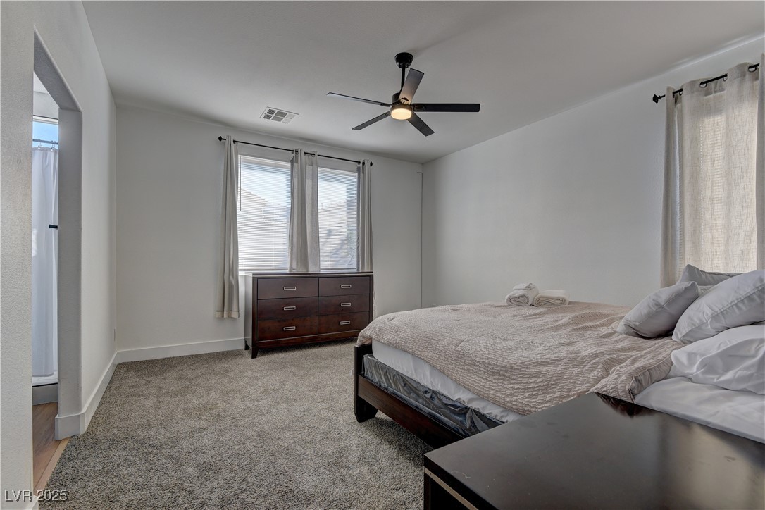 1176 Colgate Lane Las Vegas, NV 89110 - Photo 11 of 15 Bedroom featuring light colored carpet and a ceiling fan