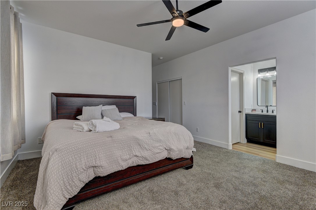 1176 Colgate Lane Las Vegas, NV 89110 - Photo 12 of 15 Bedroom featuring light colored carpet, a ceiling fan, a closet, and connected bathroom