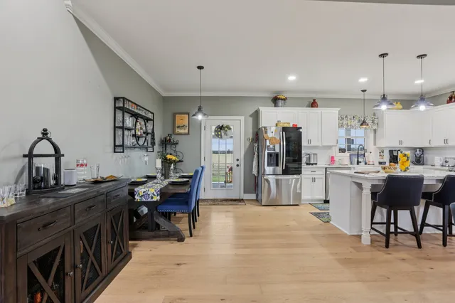 a kitchen with kitchen island granite countertop a sink stainless steel appliances and white cabinets