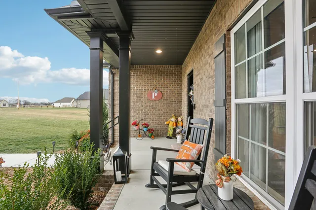 a living room with furniture and view of kitchen
