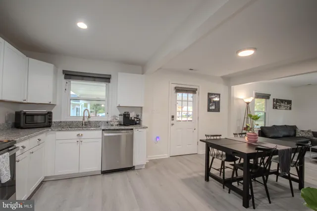 a kitchen with granite countertop a sink and cabinets