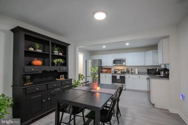 a kitchen with a dining table and chairs