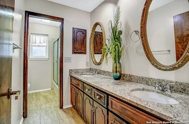 a bathroom with mirror and a sink