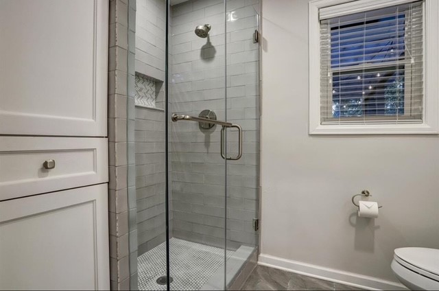 6022 Woodbrook Lane Houston, TX 77008 - Photo 11 of 20 a bathroom with a shower and toilet