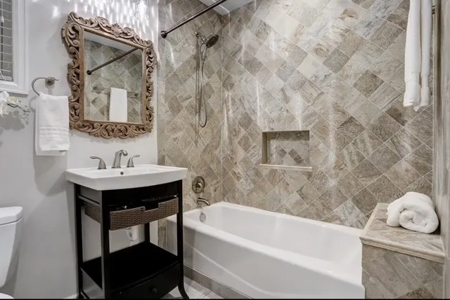 a bathroom with a sink a bathtub and a mirror