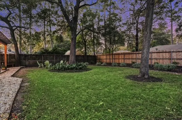 a view of a backyard with large trees