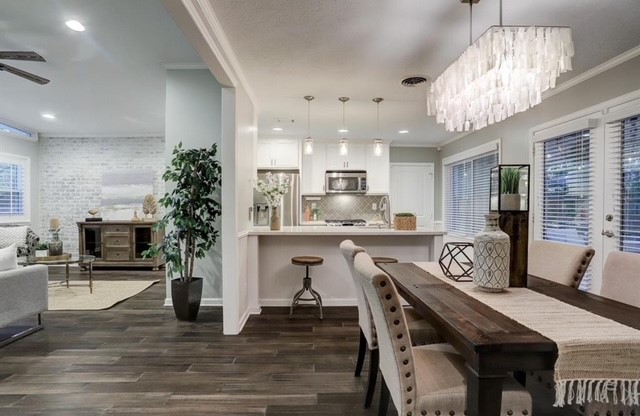 6022 Woodbrook Lane Houston, TX 77008 - Photo 4 of 20 a very nice looking dining room with kitchen island furniture a chandelier a large kitchen island and stainless steel appliances