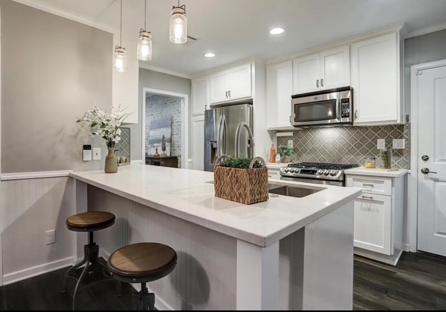 6022 Woodbrook Lane Houston, TX 77008 - Photo 6 of 20 a kitchen with stainless steel appliances a sink a stove a refrigerator and cabinets