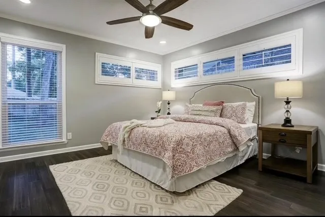 a bedroom with a large bed and a window