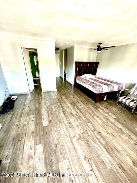 1000 Clove Road, Unit 3G Staten Island, NY 10301 - Photo 13 of 25 a bedroom with a bed and wooden floor