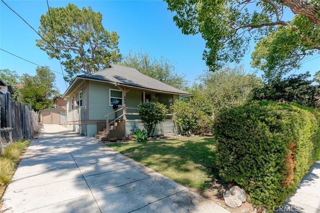 a view of a house with backyard and sitting area