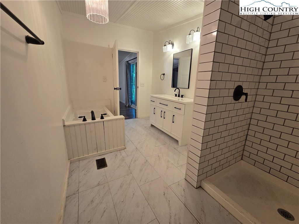 618 Rhymer Branch Road Deep Gap, NC 28618 - Photo 11 of 24 a bathroom with a bathtub and a shower