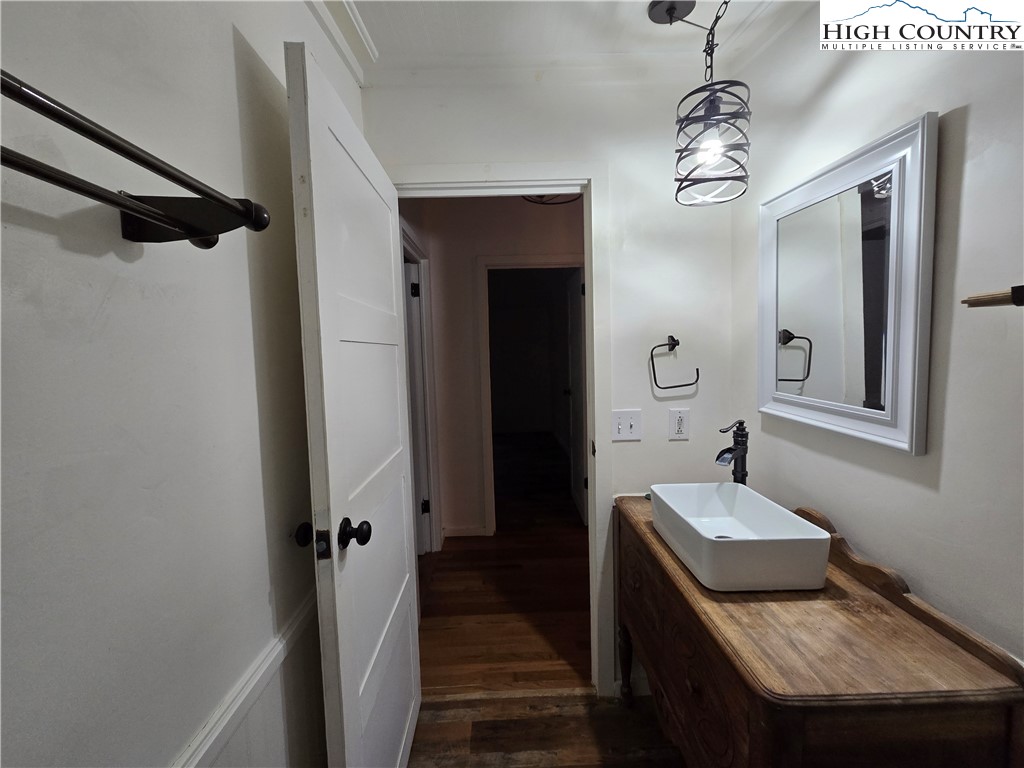 618 Rhymer Branch Road Deep Gap, NC 28618 - Photo 16 of 24 a bathroom with a granite countertop sink a mirror and shower