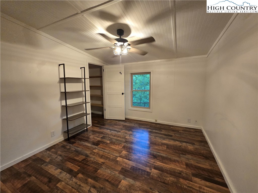 618 Rhymer Branch Road Deep Gap, NC 28618 - Photo 20 of 24 wooden floor in an empty room with a window