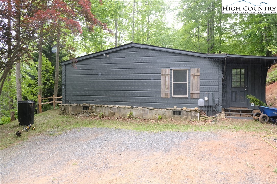618 Rhymer Branch Road Deep Gap, NC 28618 - Photo 7 of 24 a view of a house with backyard and sitting area