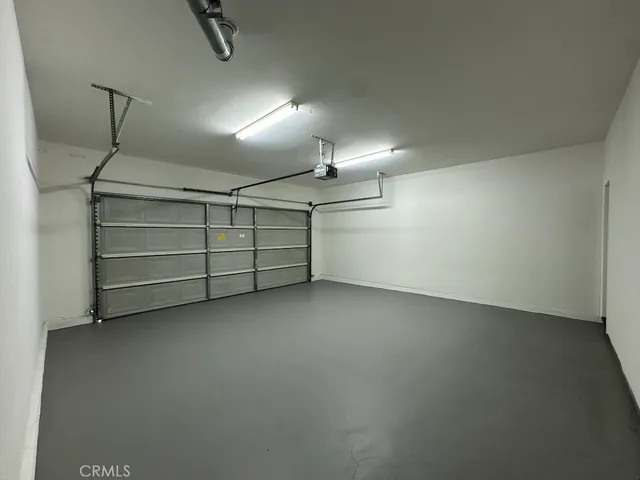 a large kitchen with stainless steel appliances granite countertop a large counter top a refrigerator and a sink