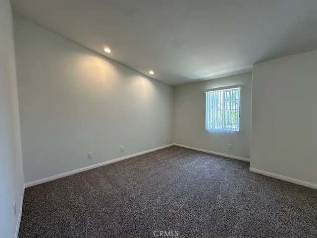 a bathroom with a granite countertop sink a mirror and a bathtub