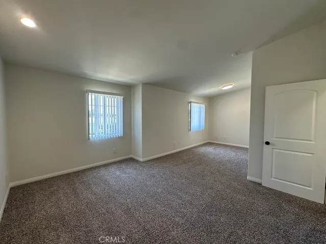 a bathroom with a granite countertop toilet sink and mirror