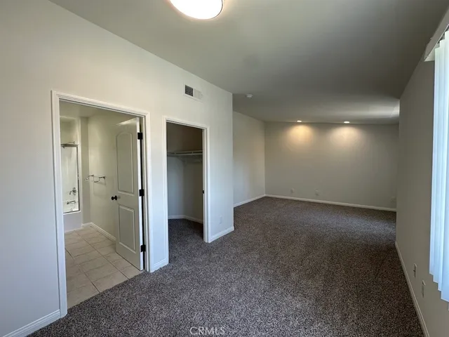 a bathroom with a granite countertop sink a toilet and a mirror
