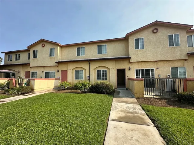 a front view of a house with a yard and porch
