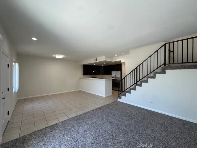 a kitchen with stainless steel appliances granite countertop a refrigerator and a stove