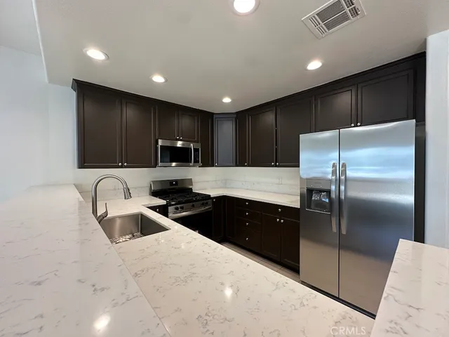 a kitchen with refrigerator and sink