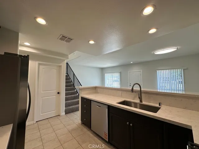 a kitchen with a sink and stainless steel appliances