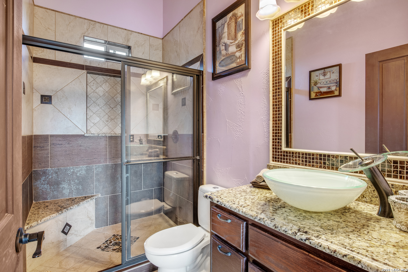 13196 Kelly Road Atascosa, TX 78002 - Photo 18 of 25 a bathroom with a granite countertop sink toilet and shower