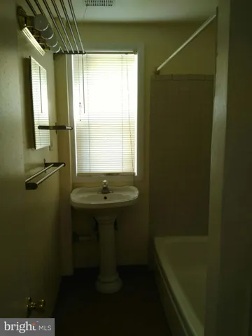 a bathroom with a sink and shower