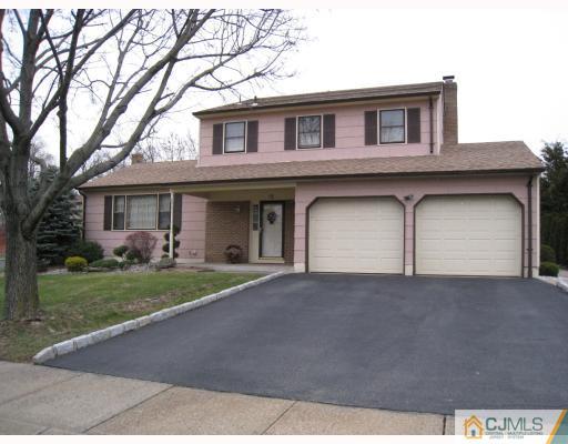 12 Roxy Avenue Edison, NJ 08820 - Photo 1 of 8 a front view of a house with a garden and garage