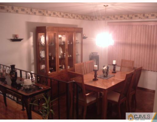 12 Roxy Avenue Edison, NJ 08820 - Photo 6 of 8 a dining room with a table and chairs