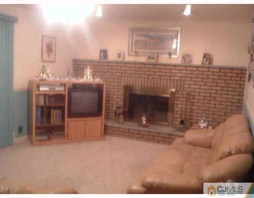 12 Roxy Avenue Edison, NJ 08820 - Photo 7 of 8 a view of a livingroom with furniture and a fireplace