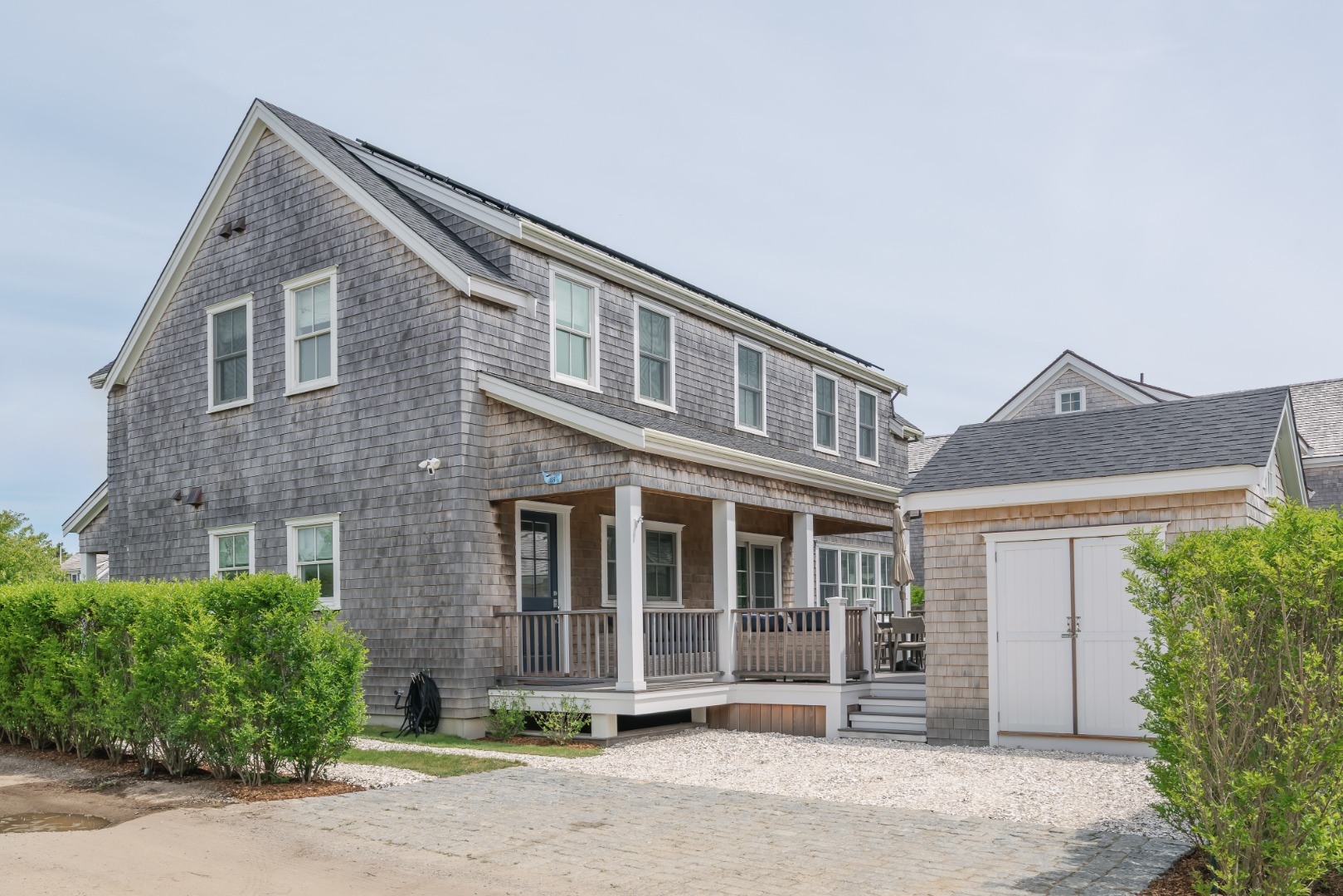 86 Cliff Road Nantucket, MA 02554 - Photo 25 of 29 a front view of a house with a yard